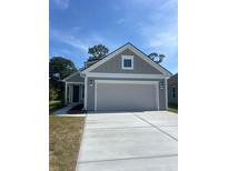Charming single-story home with gray siding, white trim, and a spacious two-car garage at 1237 Lady Bird Way, North Myrtle Beach, SC 29582