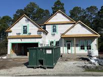 A new home under construction features a two-car garage and front porch at 2611 Painted Trillium Ct., Myrtle Beach, SC 29579