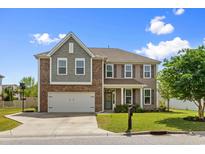 Charming two-story home with a brick and siding exterior, well-manicured lawn, and inviting front porch at 3110 Bramble Glen Dr., Myrtle Beach, SC 29579