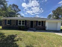 Charming brick ranch-style home with a well-maintained lawn and attached one car garage at 333 Whites Creek Rd., Georgetown, SC 29440
