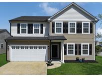Charming two-story home featuring a white garage door and black shutters against neutral siding at 4115 Alvina Way, Myrtle Beach, SC 29579