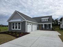 Charming single-Gathering home with a three car garage and gray siding at 414 Starlit Way, Myrtle Beach, SC 29579