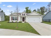 Charming single-story home featuring a two-car garage, manicured lawn, and inviting curb appeal at 742 Woodside Dr., Conway, SC 29526