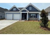 Charming single-Gathering home boasting blue siding, a two-car garage, and a well-manicured front yard at 1063 Laconic Dr., Myrtle Beach, SC 29588