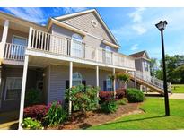 Beautiful condo exterior with spacious balcony, lush landscaping, and well-maintained grounds on a sunny day at 110 Portsmith Dr. # 8, Myrtle Beach, SC 29588