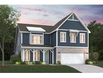 Charming two-story home with blue siding, a white garage door, and a cozy front porch at 204 Northbrook Dr, Murrells Inlet, SC 29576