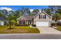 Charming home with well-manicured lawn, flowering shrubs, and a two-car garage at 293 Hillsborough Dr., Conway, SC 29526