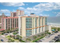 Resort building with parking, palm trees, and an ocean view in Myrtle Beach at 5300 N Ocean Blvd. # 923, Myrtle Beach, SC 29577