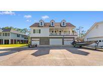 Charming two-story home with a spacious driveway and boat parking, perfect for waterfront living at 1030 Fork Retch Ct., Mullins, SC 29574
