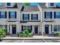 Attractive townhome exterior featuring neutral siding, black shutters, and a well-maintained lawn at 104 Barnacle Ln. # 3, Little River, SC 29566