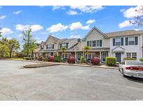 Well maintained townhome featuring manicured landscaping, palm trees and plenty of parking for residents and guests at 1046 Palisade Circle # 1046, Myrtle Beach, SC 29577