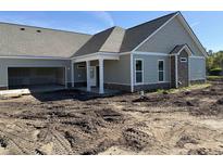 New construction home with an open garage and a covered front porch and fresh landscaping potential at 135 Stonewall Circle # 7-2, Longs, SC 29568