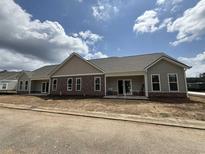 New construction home featuring mixed siding, covered entryway, and professionally landscaped yard in desirable new community at 135 Stonewall Circle # 7-2, Longs, SC 29568