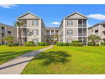 Beautiful condo building with lush green grass and landscaping at 2000 Cross Gate Blvd. # 104, Surfside Beach, SC 29575