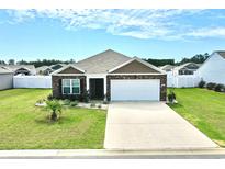 Charming brick home with a well-manicured lawn and a two-car garage, perfect for suburban living at 203 Golden Bear Circle, Longs, SC 29568