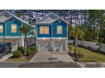 Charming blue two-story home with white trim, garage and neatly landscaped yard at 2409 Seabreeze Pl., Myrtle Beach, SC 29577