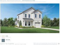 Charming two-story home featuring white siding, black roof, manicured lawn and a two-car garage at 2527 Hillbourne Loop, North Myrtle Beach, SC 29582