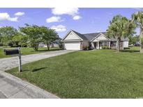 Charming single-story home featuring a well-manicured lawn and attached two-car garage at 431 Brandymill Blvd, Myrtle Beach, SC 29588