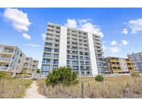 Bright white condo building with private balconies offering stunning views of the beautiful blue sky at 4311 S Ocean Blvd. # 701, North Myrtle Beach, SC 29582