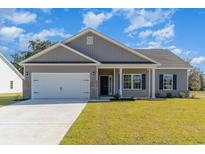 Charming single-story home with a two-car garage, brick accents, manicured lawn, and beautiful curb appeal at 108 Old Chimney Ln, Conway, SC 29526