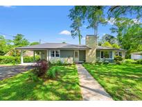 Charming single-story home with a well-manicured lawn, lush landscaping, and a welcoming walkway at 1506 7Th Ave., Conway, SC 29526