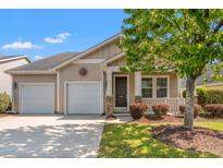 Charming single-story home featuring a two-car garage, covered porch, and well-maintained landscaping at 1524 Culbertson Ave., Myrtle Beach, SC 29577