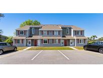 Inviting townhome exterior features classic architecture, manicured lawn and convenient parking at 1851 Colony Dr. # 4-F, Surfside Beach, SC 29575
