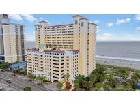 View of the condo complex with a beach view on a sunny day at 2000 N Ocean Blvd. # 502, Myrtle Beach, SC 29577