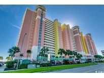 A striking high-rise condo building featuring colorful architecture and lush landscaping in a desirable location at 2711 S Ocean Blvd. # 1917, North Myrtle Beach, SC 29582