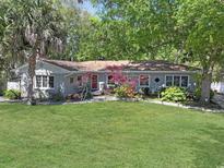 Charming one-story home with a well-maintained lawn and mature trees at 412 43Rd Ave. N, Myrtle Beach, SC 29577