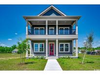 Charming two-story home featuring a double porch, stylish columns, and a beautifully landscaped front yard at 468 Saint Julian Ln., Myrtle Beach, SC 29579