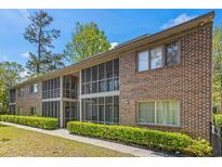 Two-story brick building featuring screened porches and well-maintained landscaping at 513 38Th Ave. N # 202, Myrtle Beach, SC 29577
