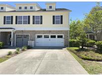 Charming townhome with a two-car garage and well-manicured front yard at 514 Hay Hill Ln. # C, Myrtle Beach, SC 29579