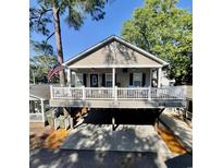 Charming coastal home featuring a spacious porch and a driveway underneath, perfect for outdoor living at 6001-1783 S Kings Hwy., Myrtle Beach, SC 29575