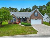 Charming single-story brick home featuring a well-manicured lawn and a welcoming red front door at 736 Lalton Dr., Conway, SC 29526
