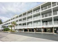 Coastal condo complex featuring multiple floors and private balconies, elevated on pilings at 9581 Shore Dr. # 223, Myrtle Beach, SC 29572