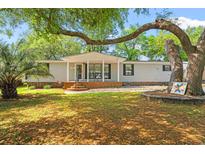 Charming single-story home with a well-maintained yard, mature trees, and inviting curb appeal at 976 South Marlin Circle, Murrells Inlet, SC 29576