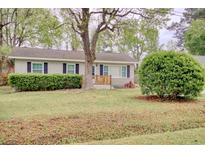 Charming single-story home with manicured lawn, shrubs, and inviting front porch at 1028 1St Ave. S, North Myrtle Beach, SC 29582