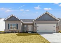 Charming single-story home with gray siding, brick accents, well-manicured lawn, and attached two-car garage at 116 Old Chimney Ln, Conway, SC 29526
