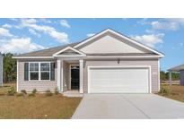 Charming single-story home featuring a two-car garage, inviting front door, and landscaped yard at 1430 Nokota Dr., Conway, SC 29526