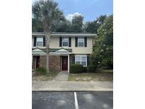 Charming townhome with brick accents, well-kept landscaping, and a classic red front door at 1432 Highway 544 # F1, Conway, SC 29526