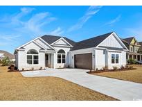 Charming single-story home with a two-car garage and well manicured landscaping at 163 Sago Palm Dr., Myrtle Beach, SC 29579