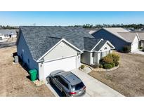 Well maintained home with a two car garage, paved driveway, and manicured landscaping at 242 Bonnie Bridge Circle, Myrtle Beach, SC 29579