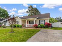 Charming single-story home with a cozy front porch and well-maintained landscaping at 2446 Farmwood Circle, Conway, SC 29527