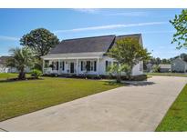 Charming single-story home with a well-manicured lawn and long driveway at 2703 Canvasback Trail, Myrtle Beach, SC 29588