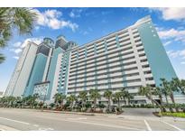 Stunning beachfront condo building boasts balconies and palm trees along the street at 3000 N Ocean Blvd. # 1020, Myrtle Beach, SC 29577