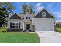 Charming home with a two-car garage, brick accents, neutral siding and a well-manicured lawn at 438 Lifestyle Court, Surfside Beach, SC 29575