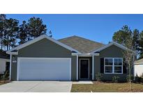 Charming one-story home featuring a 2-car garage, neat landscaping, and neutral color palette at 4488 East Coast Ln., Shallotte, NC 28470