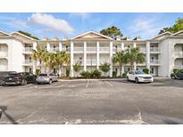 Condo exterior featuring white facade, multiple stories, balconies, palm trees, and ample parking at 4567 Eastport Blvd. # P, Little River, SC 29566