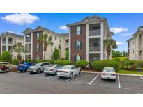 View of exterior and parking for this lovely condo community with lush landscaping at 480 River Oaks Dr. # 63-O, Myrtle Beach, SC 29579
